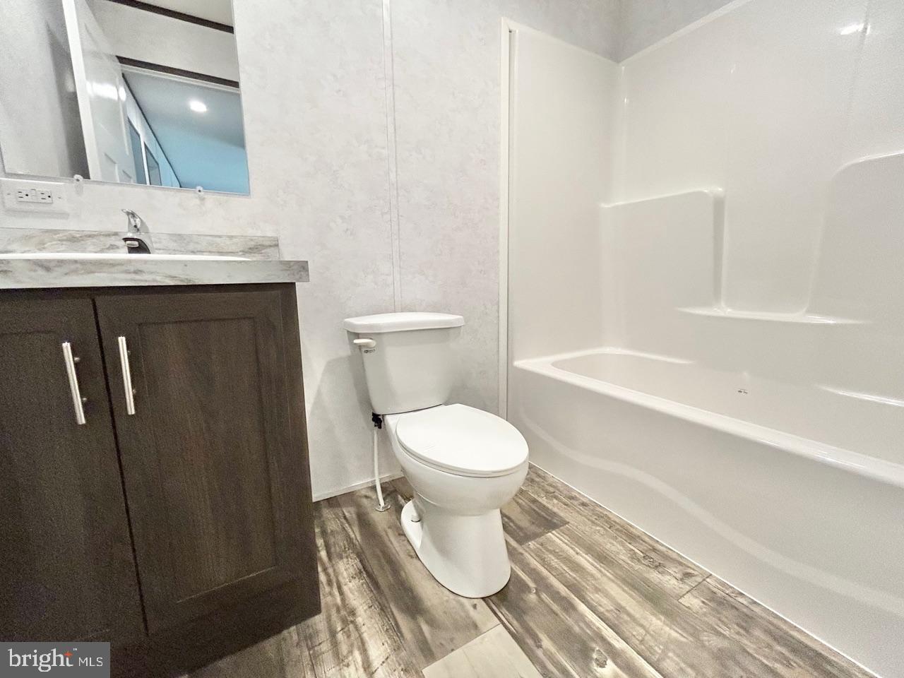 7086 James Moore Road Port Norris, NJ 08349 - Photo 13 of 22 a bathroom with a toilet a sink and bathtub