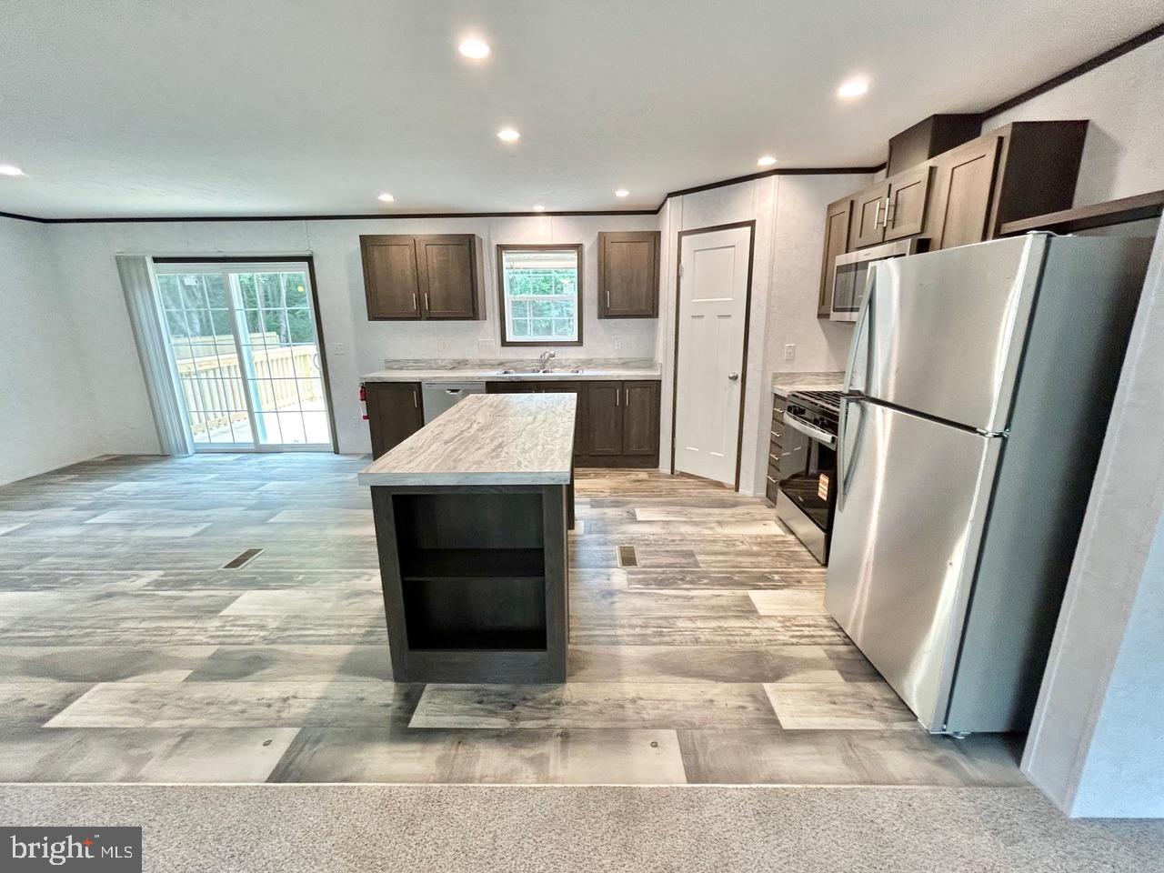 7086 James Moore Road Port Norris, NJ 08349 - Photo 3 of 22 a kitchen with stainless steel appliances granite countertop a refrigerator a stove and a sink