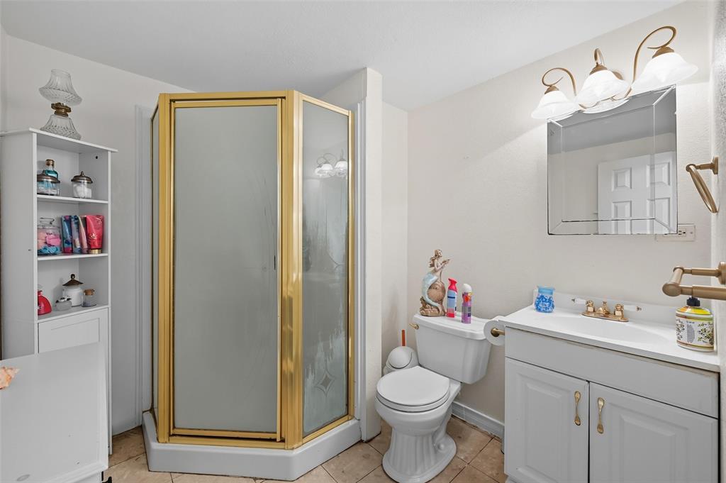 3334 Sheldon Avenue Dallas, TX 75211 - Photo 19 of 22 Full bathroom featuring vanity, a shower stall, and light tile patterned flooring