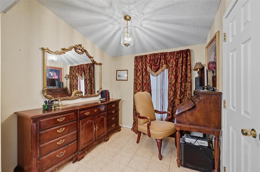 3334 Sheldon Avenue Dallas, TX 75211 - Photo 10 of 22 Sitting room with light tile patterned floors, a textured ceiling, and a chandelier