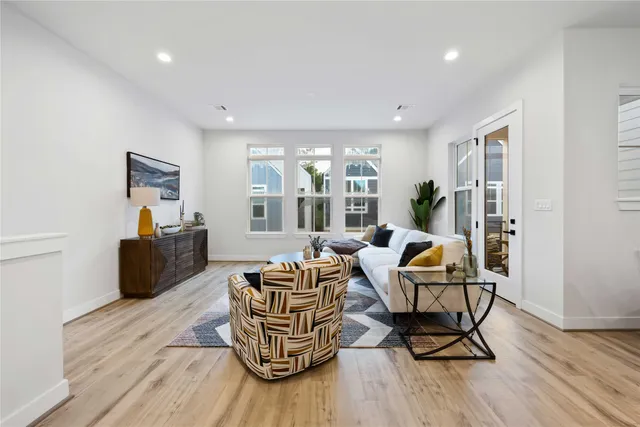 a living room with furniture and a wooden floor