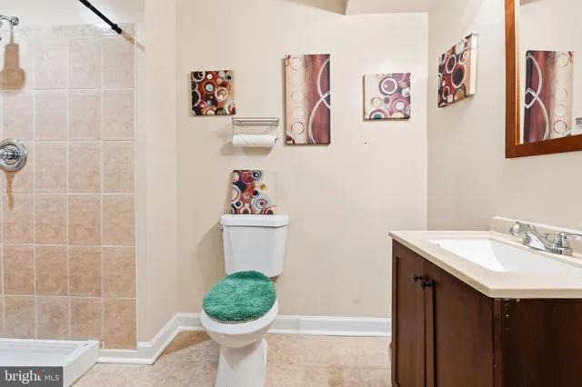 a bathroom with a sink mirror and toilet
