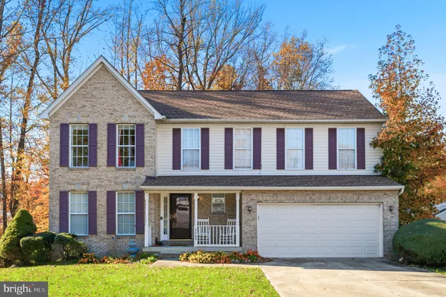 a front view of a house with yard and garage