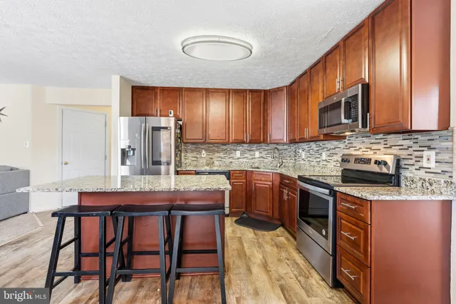 a view of a livingroom with furniture and stairs