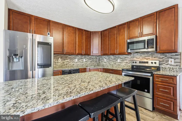 a living room with furniture a rug and a book shelf