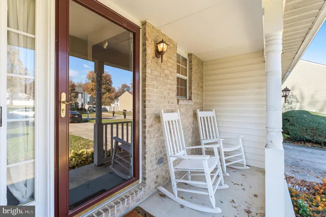 a dining room with furniture a chandelier and window