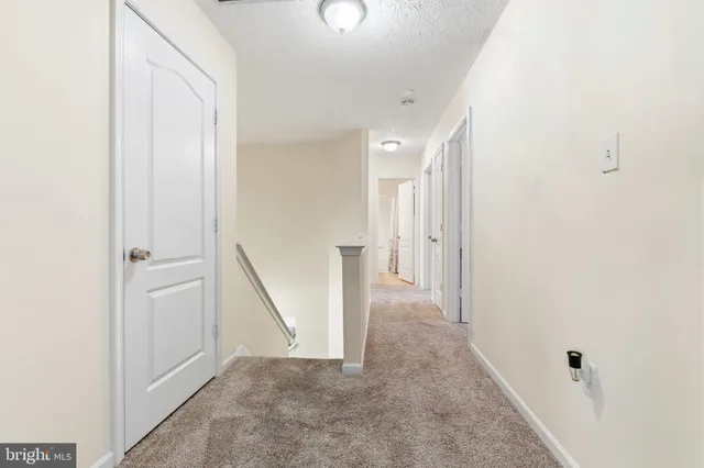 a view of a hallway with staircase