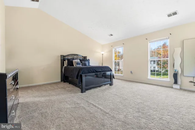 a room with a bed and a large window