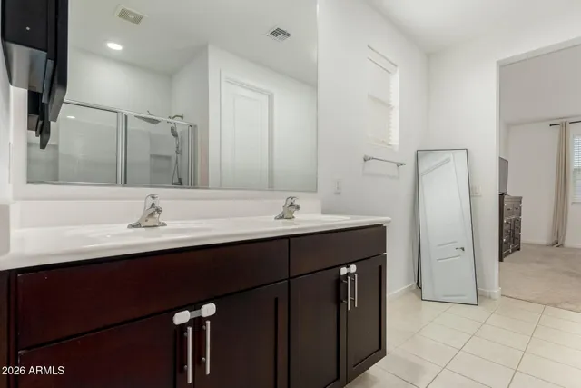 a bathroom with a double vanity sink and a mirror