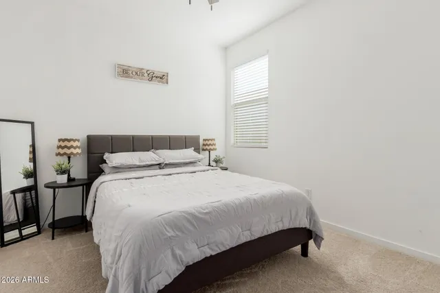 a bed sitting in a bedroom next to a window