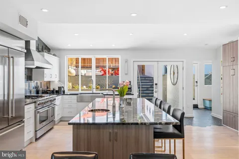 a kitchen with stainless steel appliances granite countertop a stove and a sink