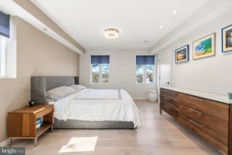 a bedroom with a bed and a night stand