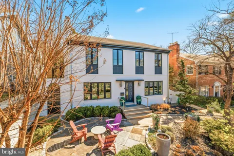 a backyard of a house with yard and outdoor seating
