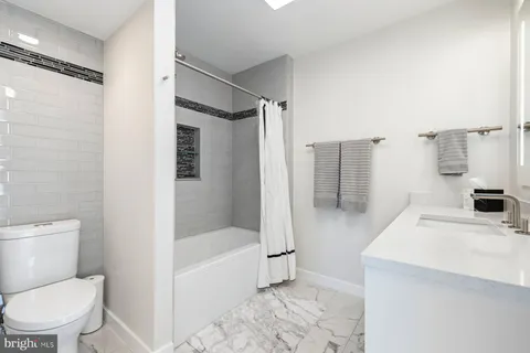 a bathroom with a bathtub toilet and shower