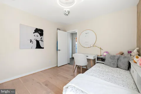 a living room with furniture a clock and a window