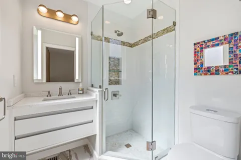 a bathroom with a shower a sink and a mirror
