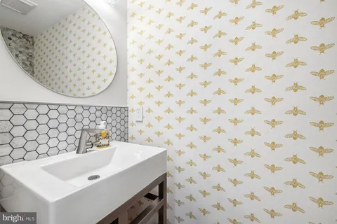 a bathroom with a sink a mirror and a shower curtain