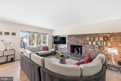 a living room with fireplace furniture and a flat screen tv