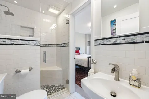 a bathroom with a sink toilet and shower