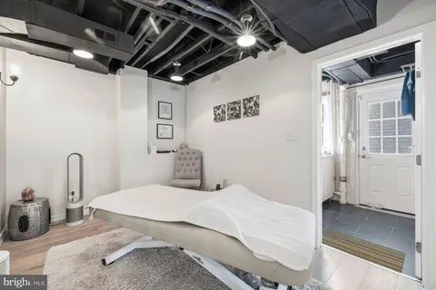 a spacious bedroom with a bed and a large window