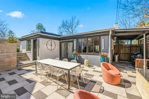 a view of a patio with couches table and chairs and potted plants