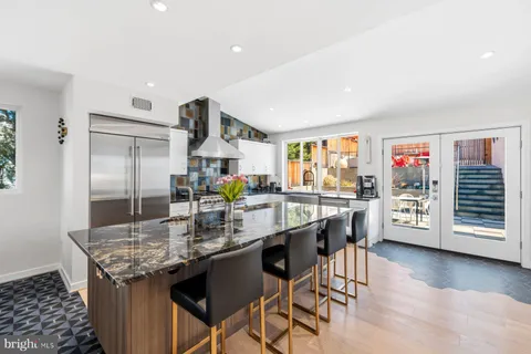 a kitchen with stainless steel appliances granite countertop a stove and refrigerator