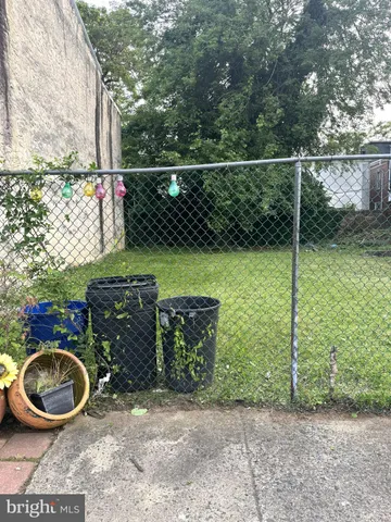 a backyard of a house with lots of green space and fountain
