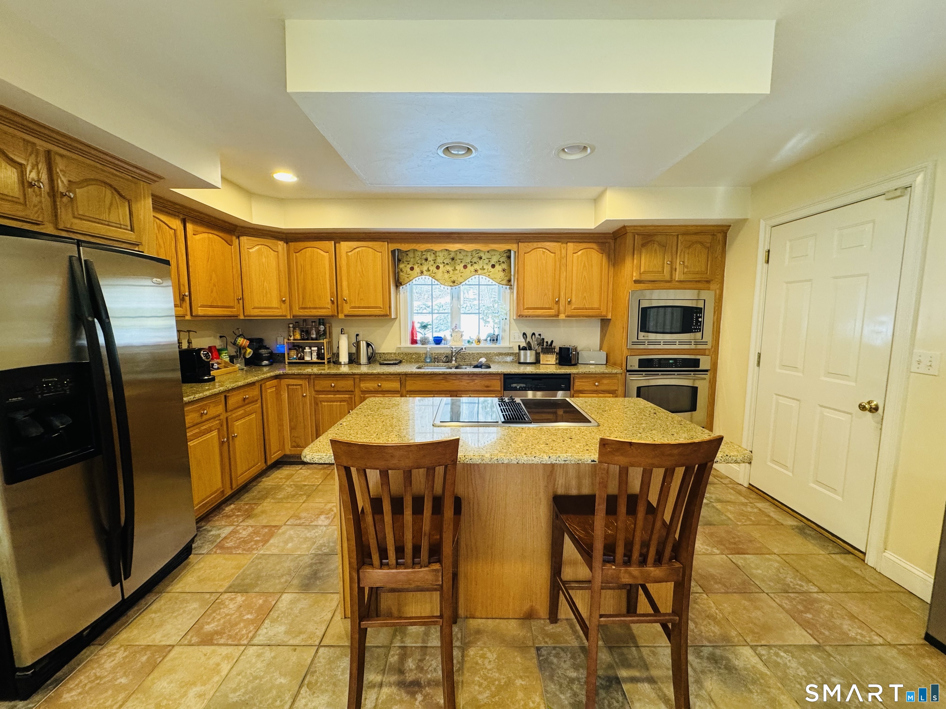 1350 Thompson Road Thompson, CT 06277 - Photo 8 of 39 a dining room with stainless steel appliances a dining table and chairs