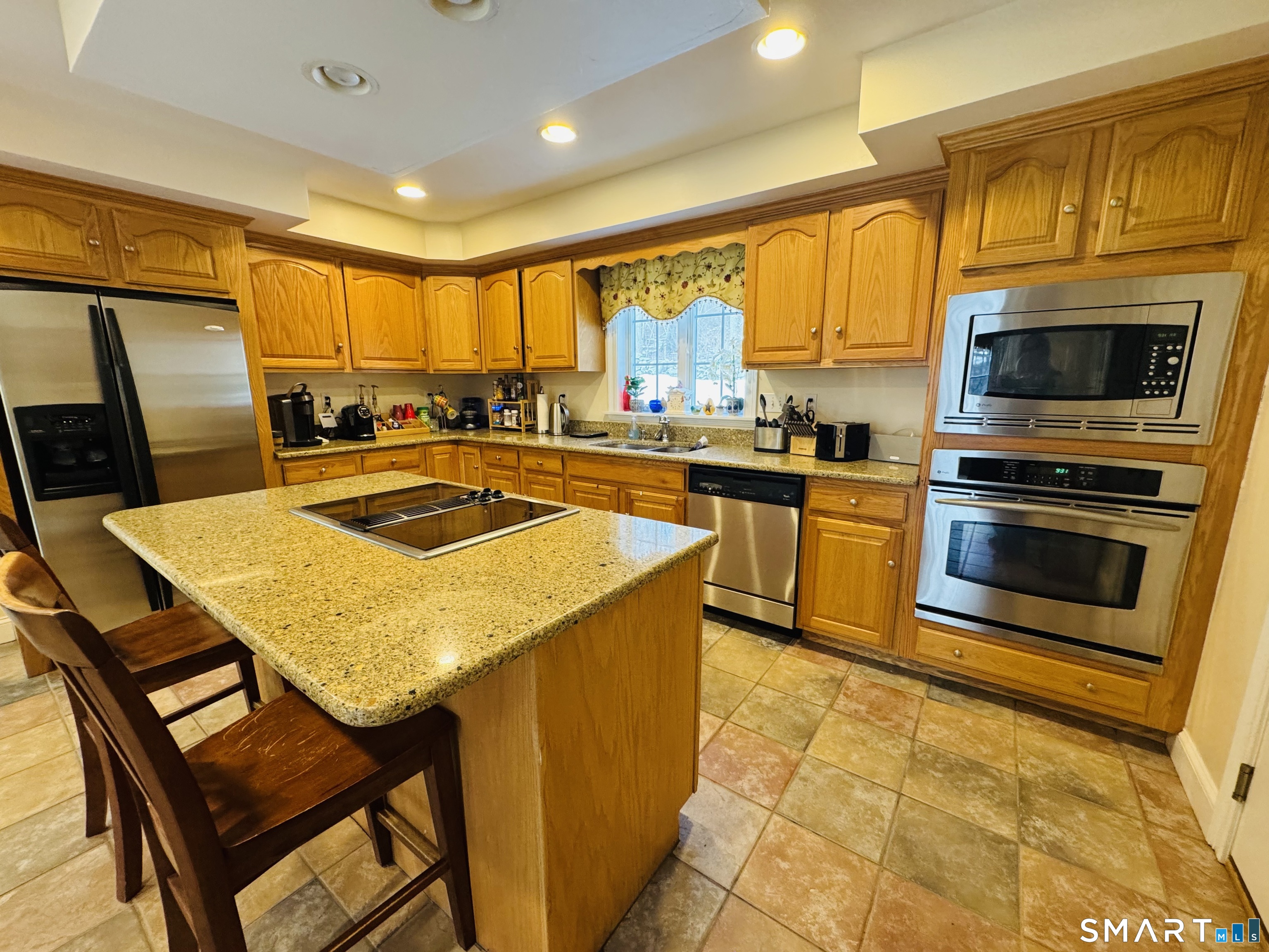 1350 Thompson Road Thompson, CT 06277 - Photo 9 of 39 a kitchen with a stove a sink and a microwave