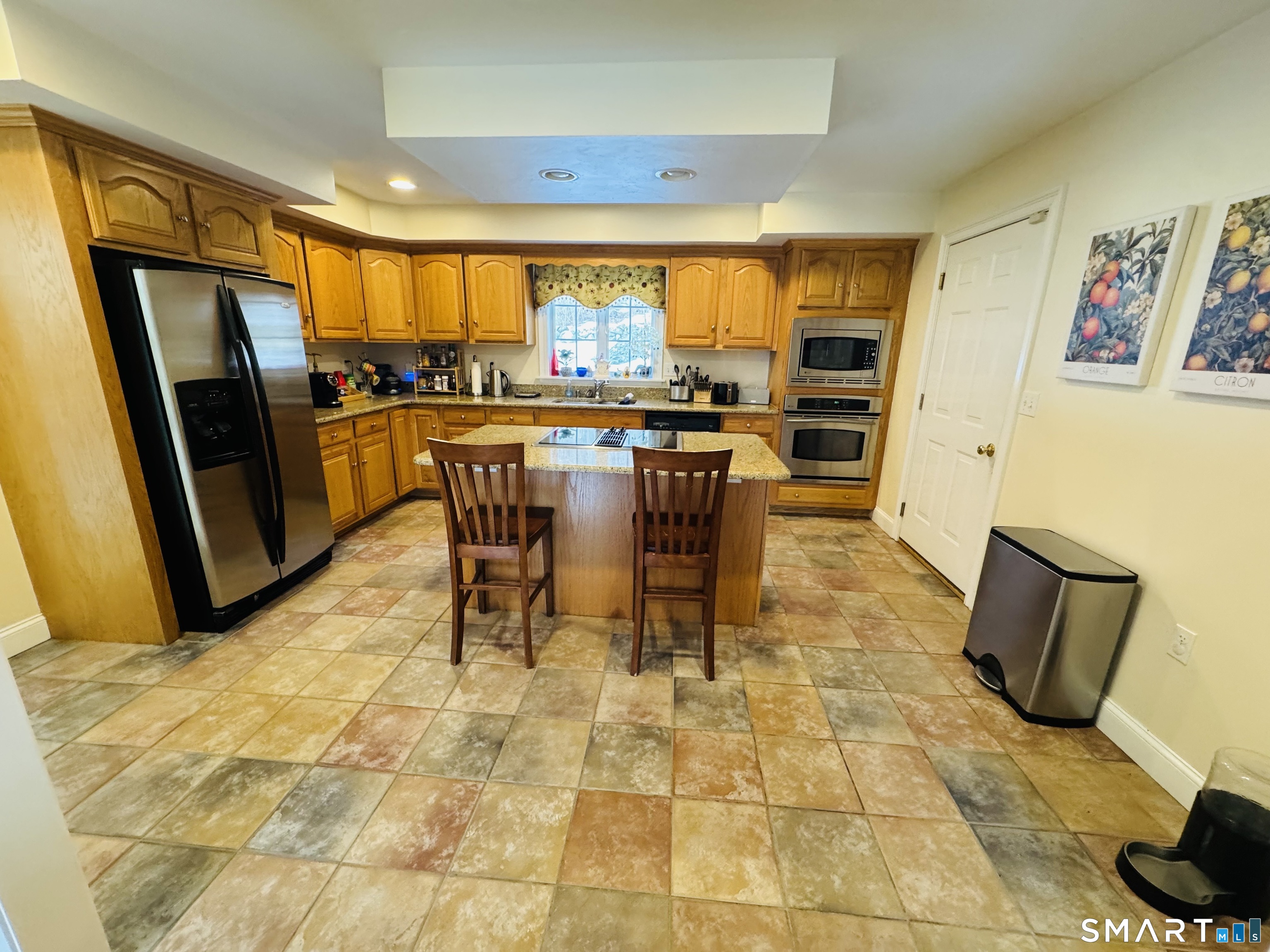 1350 Thompson Road Thompson, CT 06277 - Photo 10 of 39 a dining room with stainless steel appliances a dining table and chairs in it
