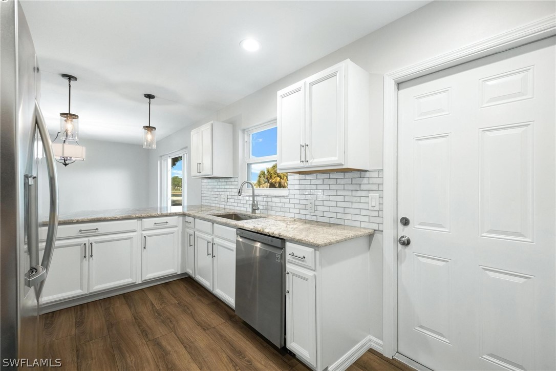 1453 River Road Moore Haven, FL 33471 - Photo 11 of 39 a kitchen with granite countertop white cabinets and white appliances