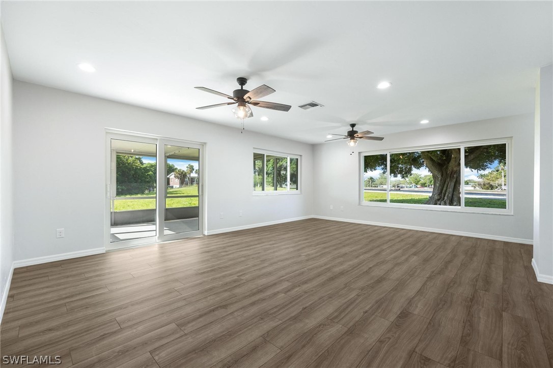 1453 River Road Moore Haven, FL 33471 - Photo 13 of 39 a view of an empty room with a window and wooden floor