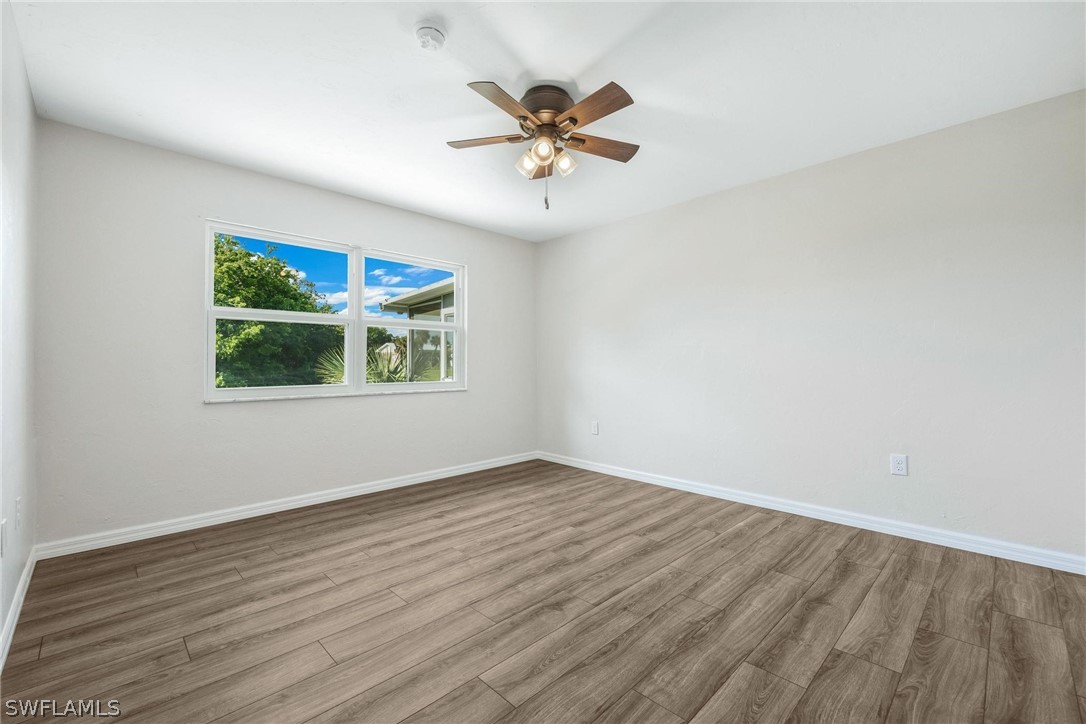 1453 River Road Moore Haven, FL 33471 - Photo 21 of 39 a view of an empty room with window and wooden floor
