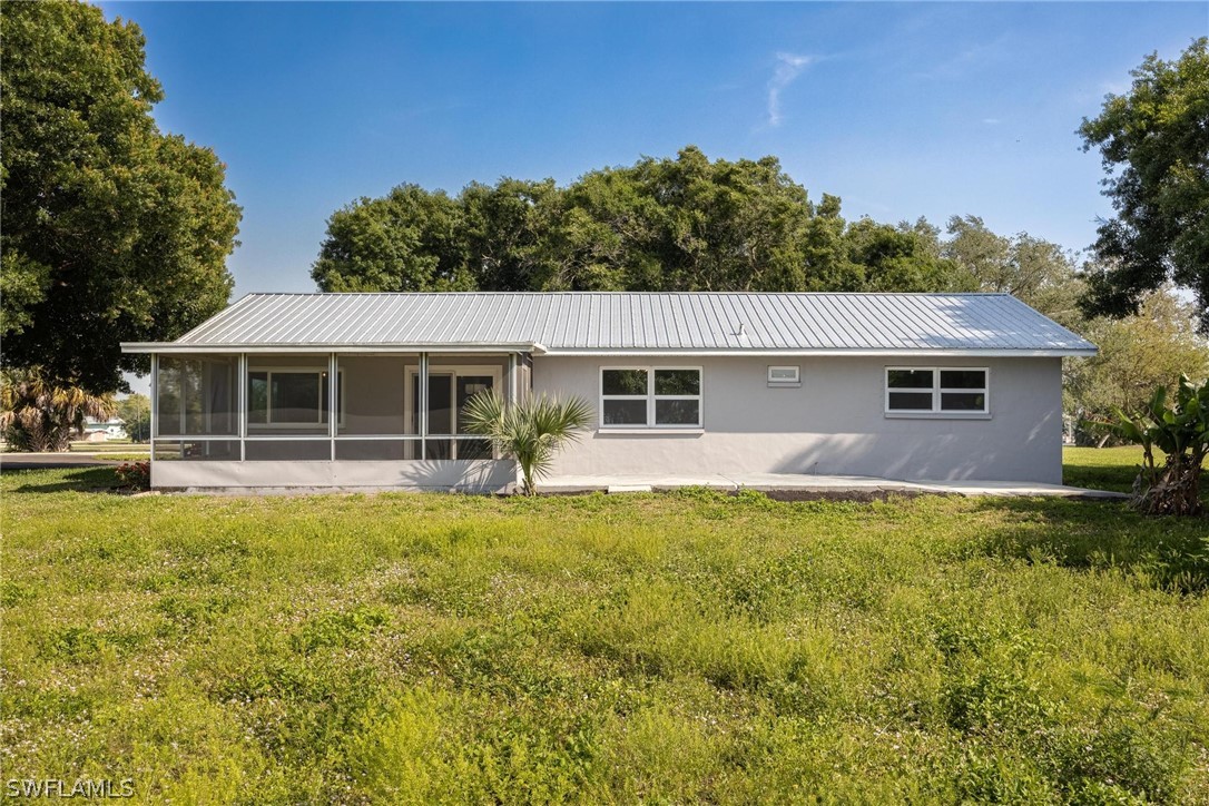 1453 River Road Moore Haven, FL 33471 - Photo 30 of 39 a front view of a house with a yard