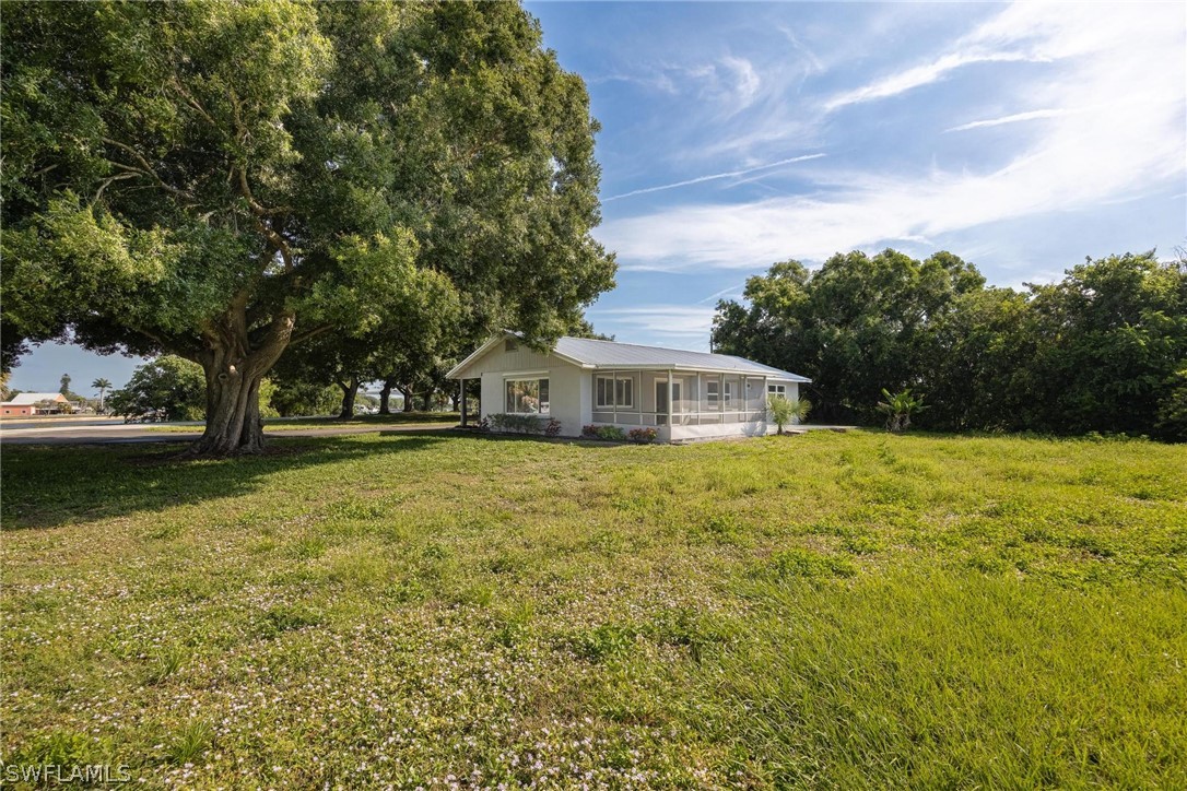 1453 River Road Moore Haven, FL 33471 - Photo 32 of 39 a front view of a house with a yard