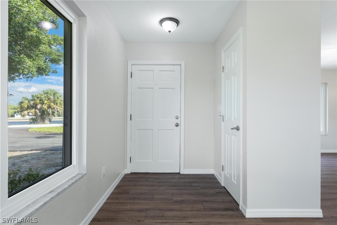1453 River Road Moore Haven, FL 33471 - Photo 4 of 39 a view of a hallway with wooden floor and a floor to ceiling window