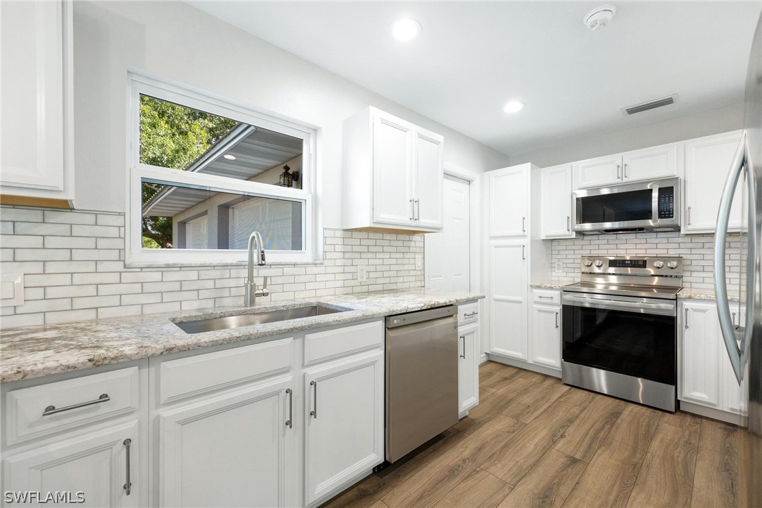 1453 River Road Moore Haven, FL 33471 - Photo 7 of 39 a kitchen with cabinets appliances a sink and a window