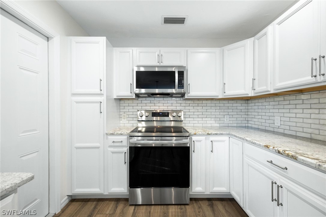 1453 River Road Moore Haven, FL 33471 - Photo 9 of 39 a kitchen with a stove and a microwave