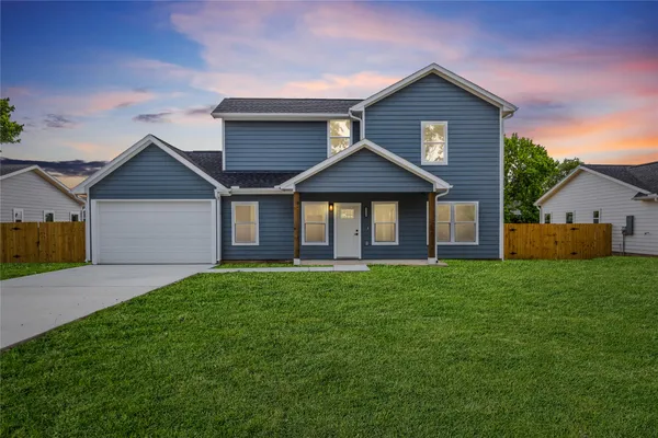 a front view of a house with a yard