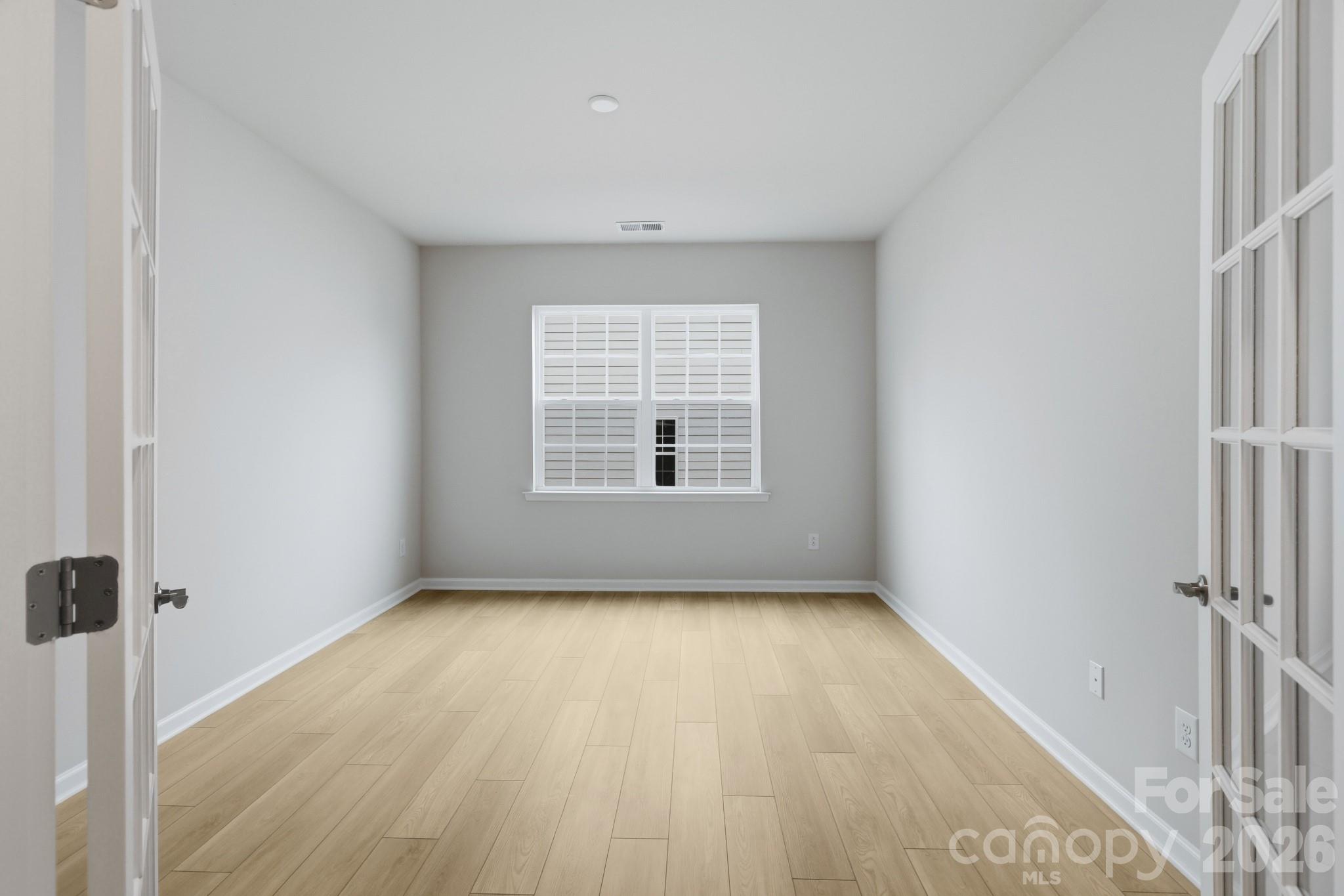 5450 Redbud Road, Unit 66 Lancaster, SC 29720 - Photo 8 of 35 an empty room with wooden floor and windows