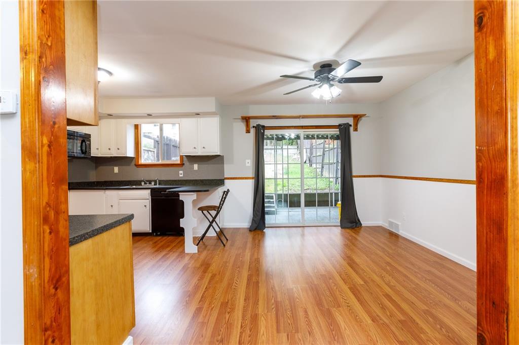 826 Ridge Avenue McKees Rocks, PA 15136 - Photo 6 of 22 a kitchen with granite countertop a stove a sink and a refrigerator