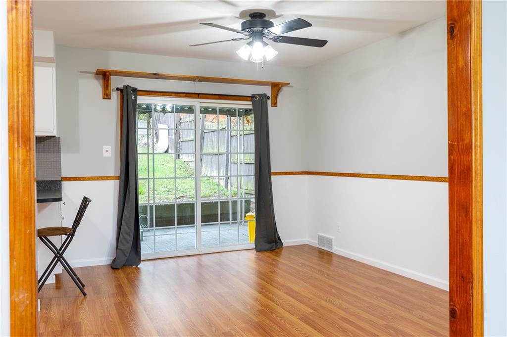 826 Ridge Avenue McKees Rocks, PA 15136 - Photo 7 of 22 a view of an empty room with wooden floor and a window