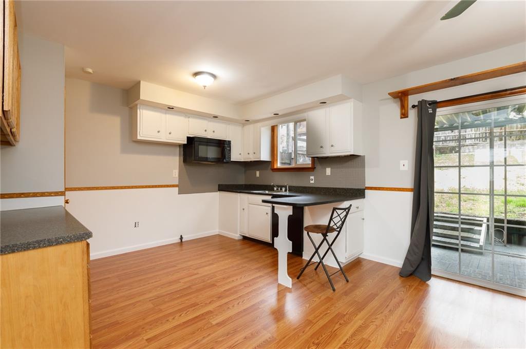 826 Ridge Avenue McKees Rocks, PA 15136 - Photo 10 of 22 a kitchen with stainless steel appliances granite countertop a stove a sink and a refrigerator