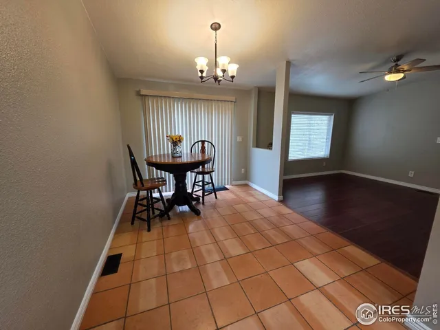 a view of a dining room with furniture and chandelier
