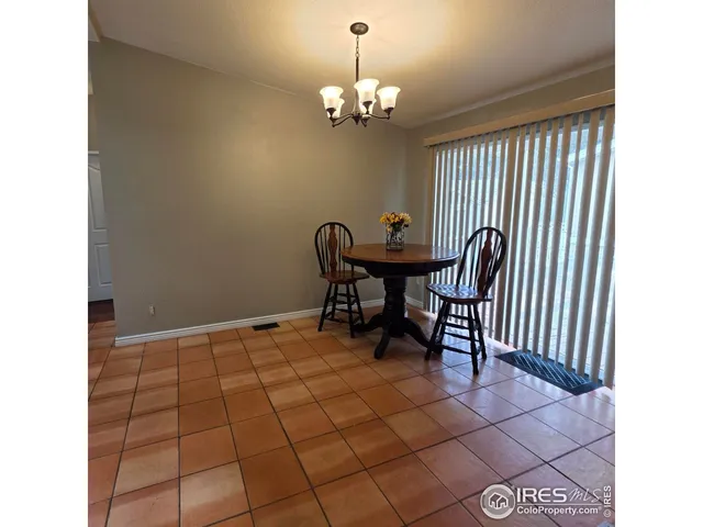 a view of a dining room with furniture and chandelier