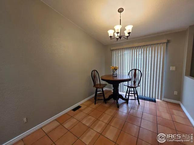 a view of a dining room with furniture and chandelier