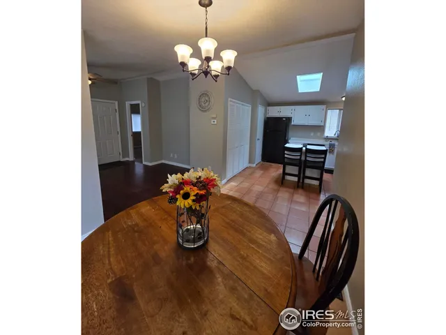 a view of a dining room with furniture and chandelier
