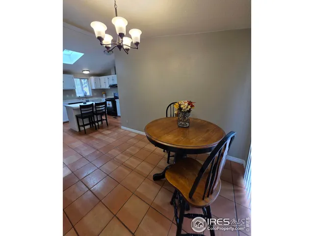 a view of a dining room with furniture and chandelier