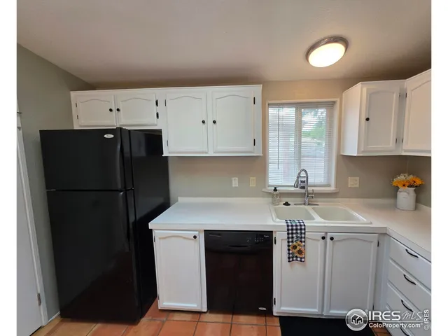 a kitchen with a sink a stove a refrigerator and cabinets