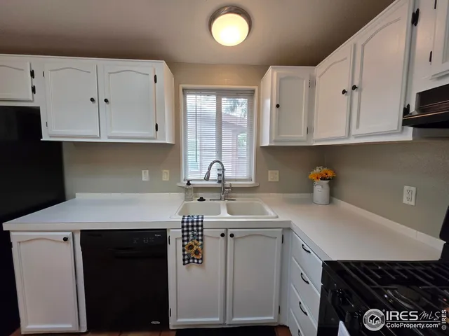 a kitchen with kitchen island granite countertop a sink a stove a microwave and cabinets